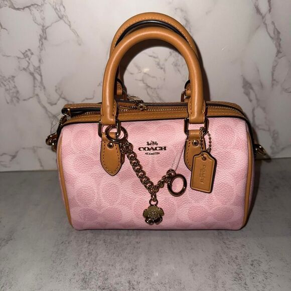 Coach Handbags - Coach powder pink mini Rowan with charms